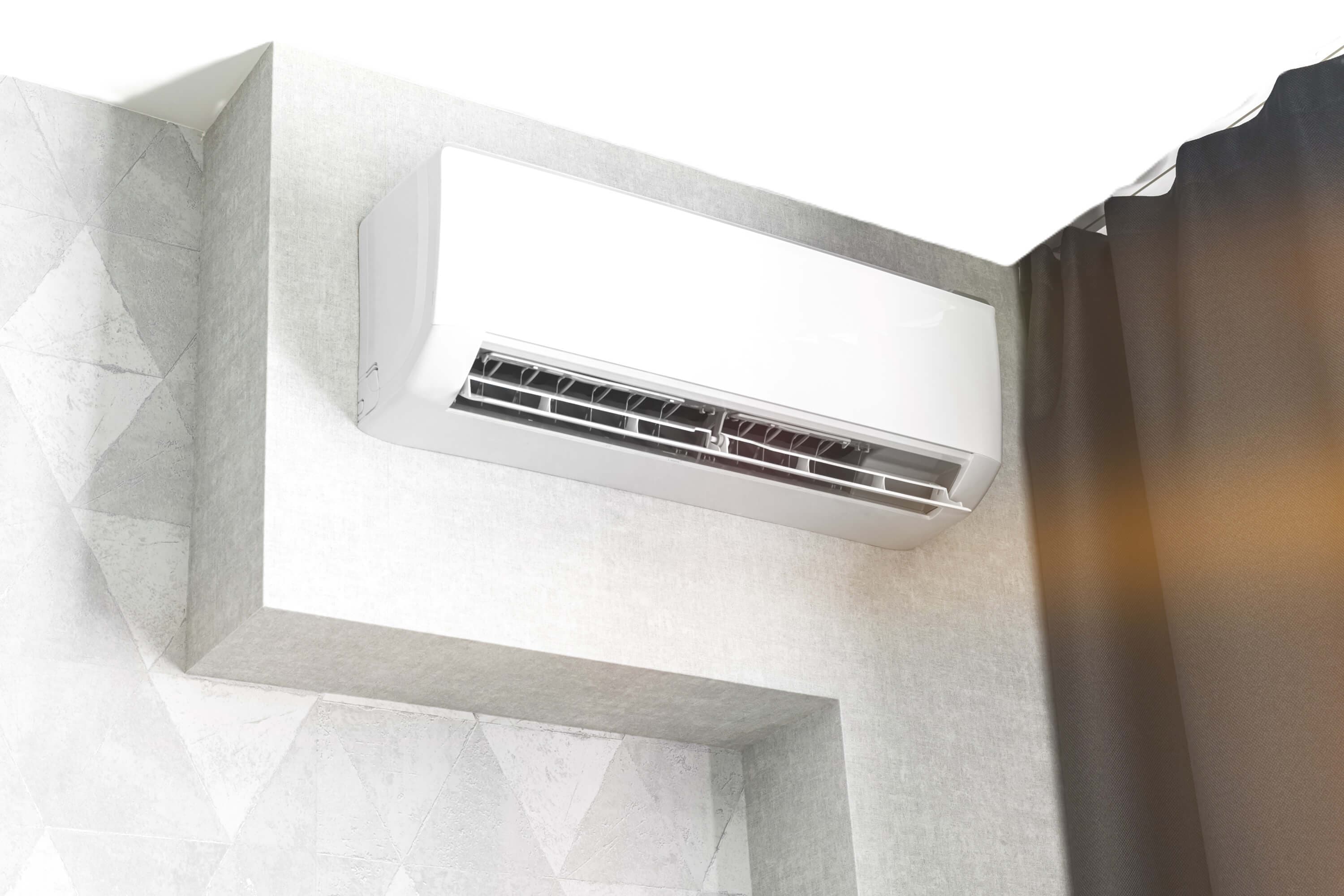 A person installing an air conditioner.